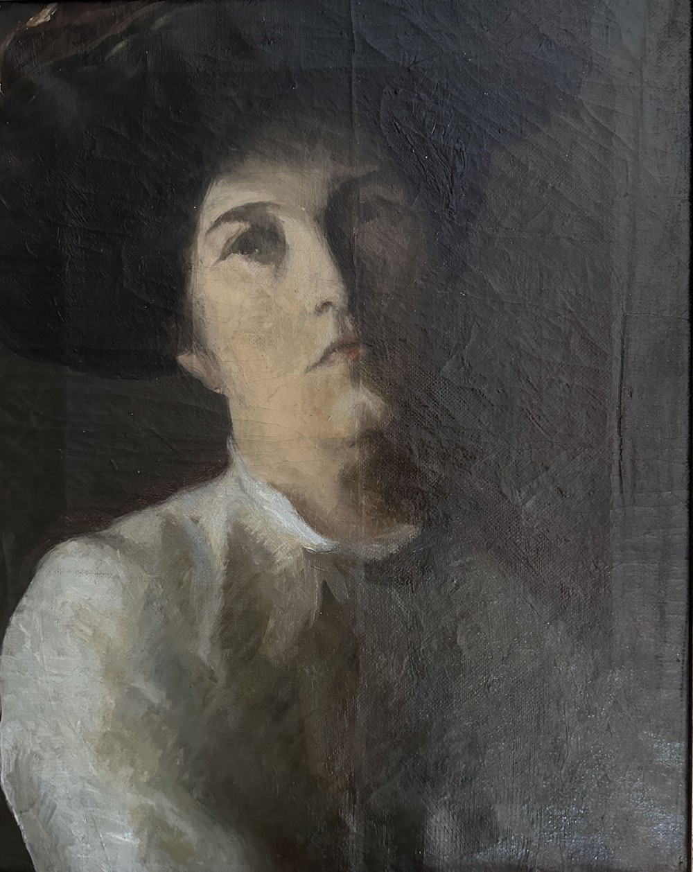 An antique oil painting on canvas depicting a woman wearing a dark hat and light-coloured blouse in low-light illumination. View IV