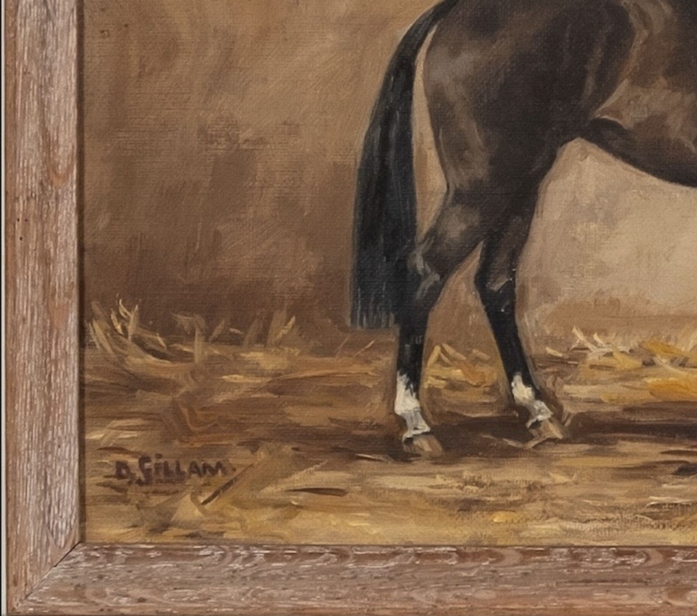 An antique oil painting depicting a dark bay horse standing in profile in a stable on a bed of straw, signed D. Gillam. View VI