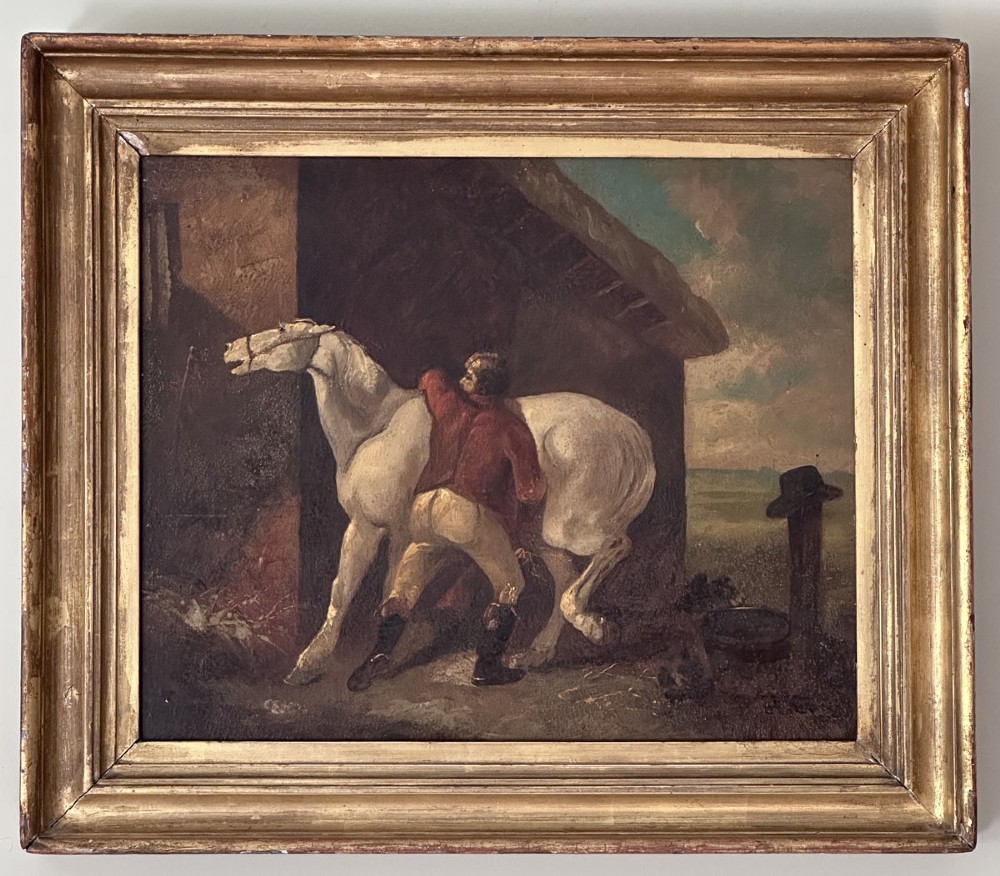 An antique oil painting depicting a groom in a red jacket attending to a white horse beside a rustic barn exterior. View III
