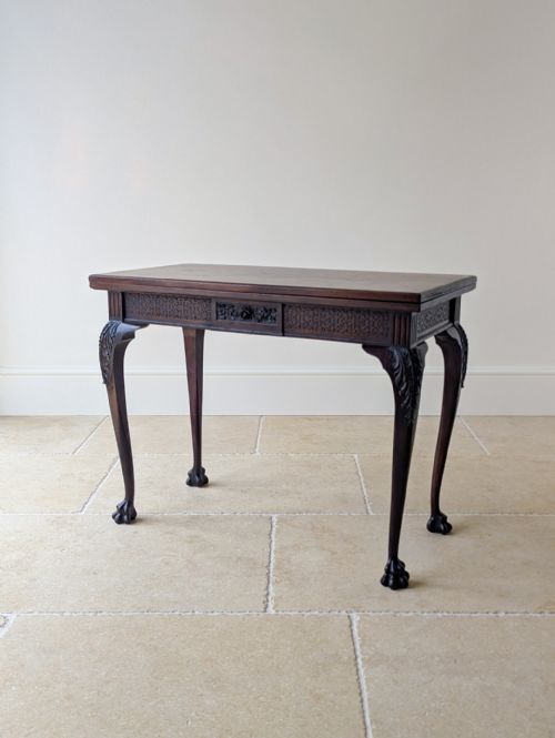 fig 1. A square Victorian dark mahogany card table with a green baize playing surface, carved cabriole legs, ball-and-claw feet, and corner counter wells.