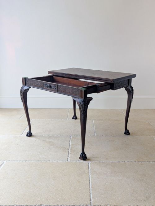 fig 2. A square Victorian dark mahogany card table with a green baize playing surface, carved cabriole legs, ball-and-claw feet, and corner counter wells.