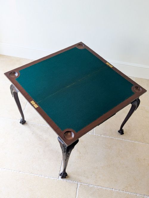 fig 3. A square Victorian dark mahogany card table with a green baize playing surface, carved cabriole legs, ball-and-claw feet, and corner counter wells.