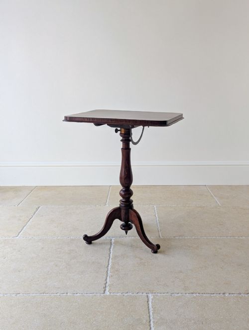 fig 1. An antique William IV rosewood reading stand featuring a rectangular tilted top on an adjustable turned pedestal with a tripod base.