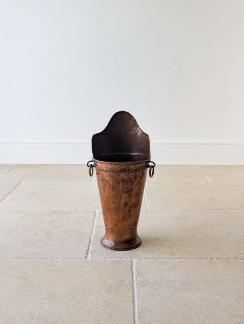 fig 1. A tall, hand-hammered French copper grape hod featuring a raised back rim, brass ring handles, and a flared base.