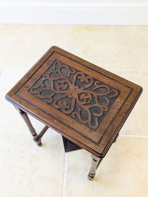 fig 1. A late Victorian dark walnut occasional table with slender turned legs, an H-stretcher, and a carved scrollwork top panel.
