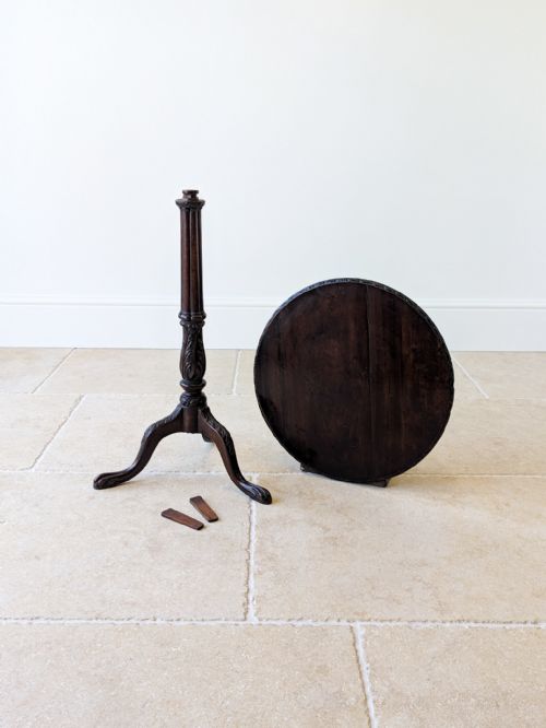 fig 1. A dark mahogany tripod wine table with a circular top, turned carved column stem, and three cabriole legs.