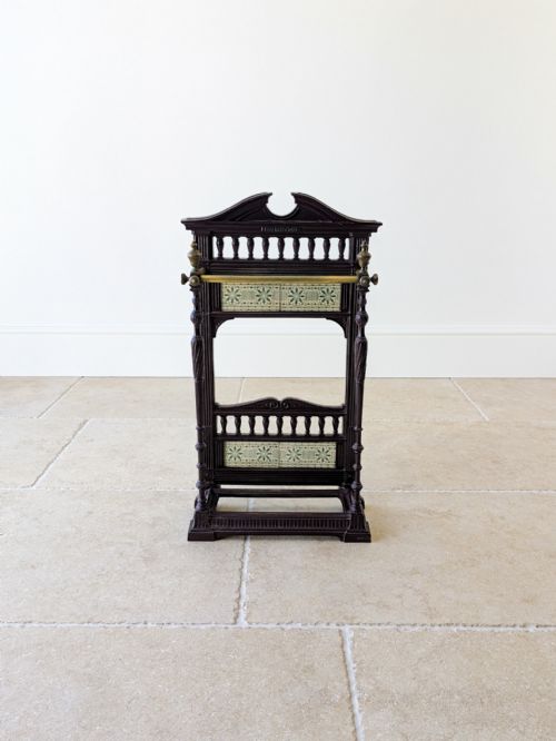 fig 1. An Edwardian cast iron stick stand featuring decorative ceramic tiles, turned spindles, and a brass front rail.