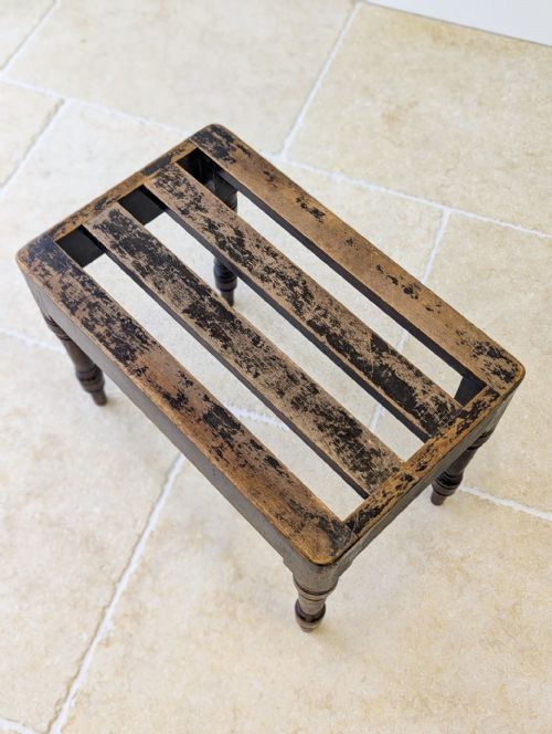 fig 1. A Victorian dark brown beech wooden luggage stand featuring a slatted top and turned legs.