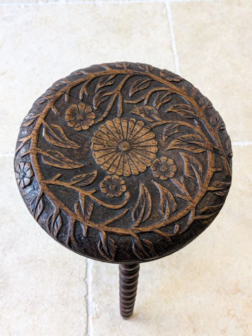 fig 1. A late nineteenth-century Victorian dark oak tripod stool featuring a circular carved seat top and three bobbin-turned legs with a matching central stretcher.