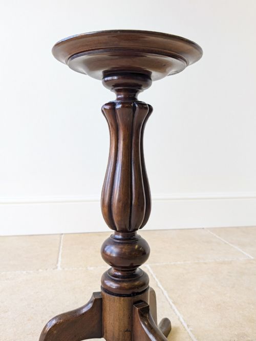 fig 1. A late Victorian dark mahogany candle stand featuring a dished circular top supported by a carved fluted central column and three out-swept legs.