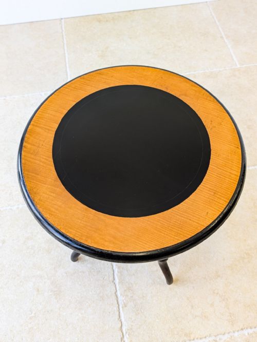 fig 1. A Victorian Aesthetic Movement circular occasional table featuring an ebonised finish with turned legs, gilt highlights, and a central cross-stretcher.