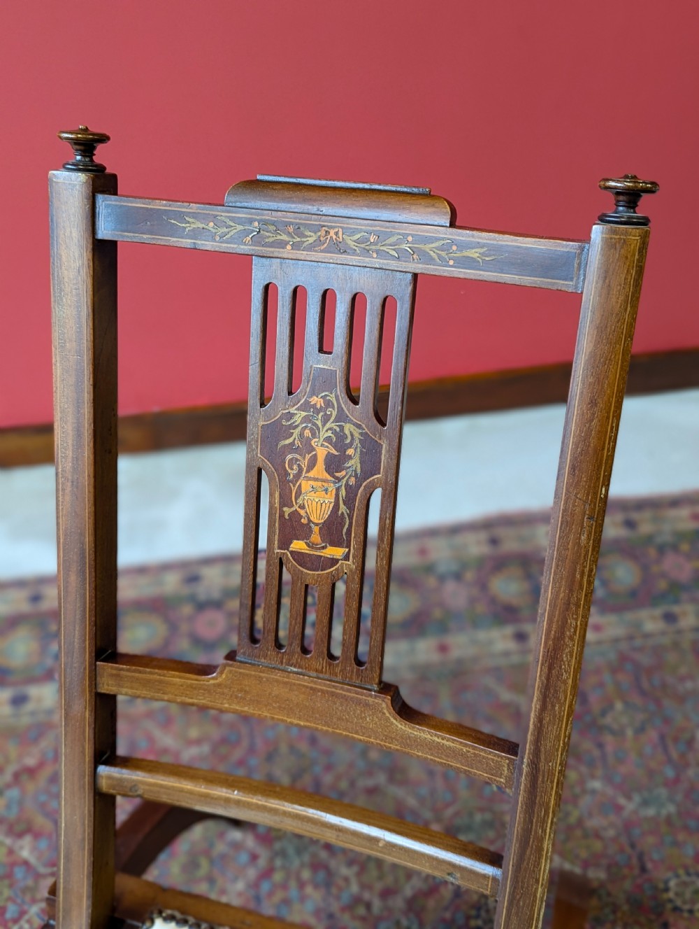 An antique Edwardian folding campaign chair made of mahogany featuring marquetry inlay and an upholstered seat pad. View III