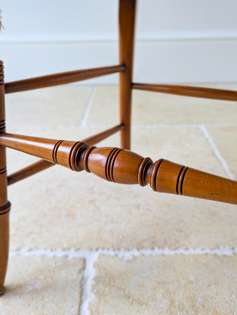 A late Victorian satinwood elbow chair featuring a lyre-shaped backrest with a painted central medallion, turned front legs, and an upholstered seat. View XIV
