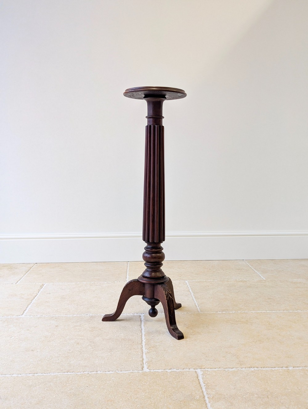 A dark mahogany William IV torchere stand featuring a fluted column shaft resting on a turned tripod base. View VI