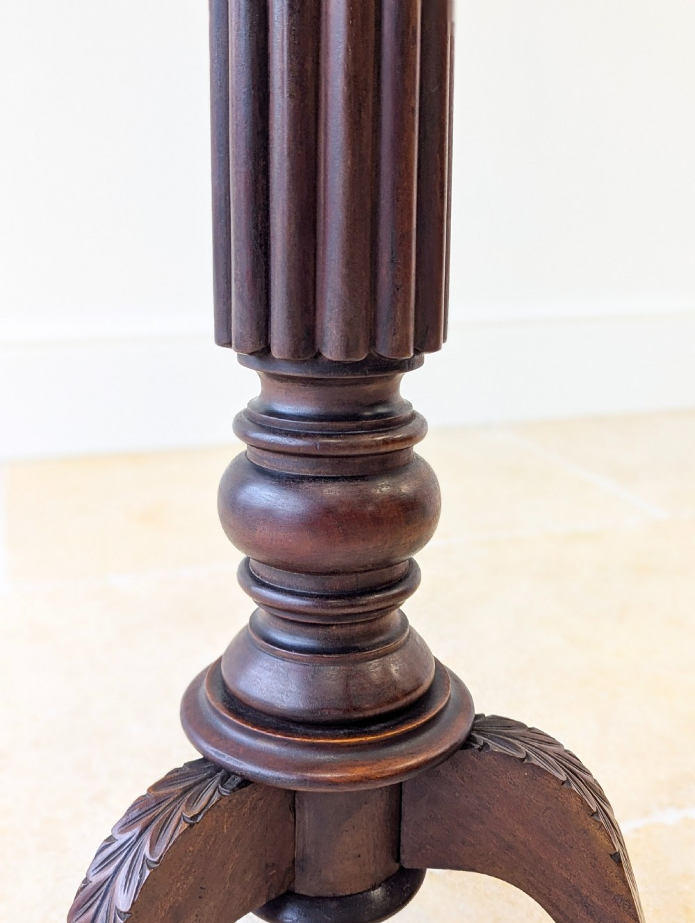 A dark mahogany William IV torchere stand featuring a fluted column shaft resting on a turned tripod base. View IX
