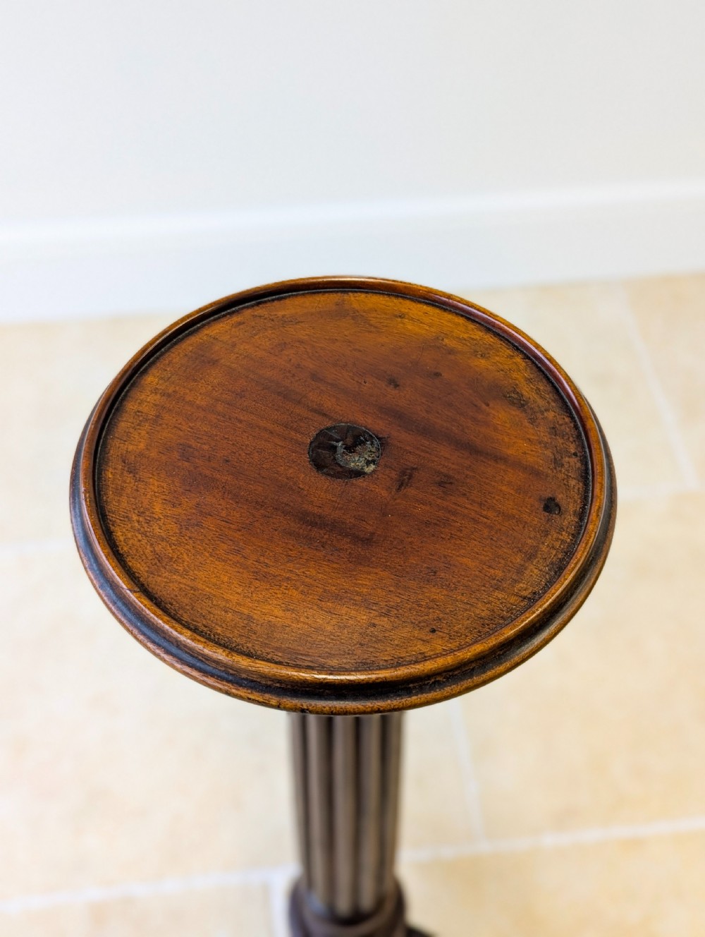 A dark mahogany William IV torchere stand featuring a fluted column shaft resting on a turned tripod base. View XI