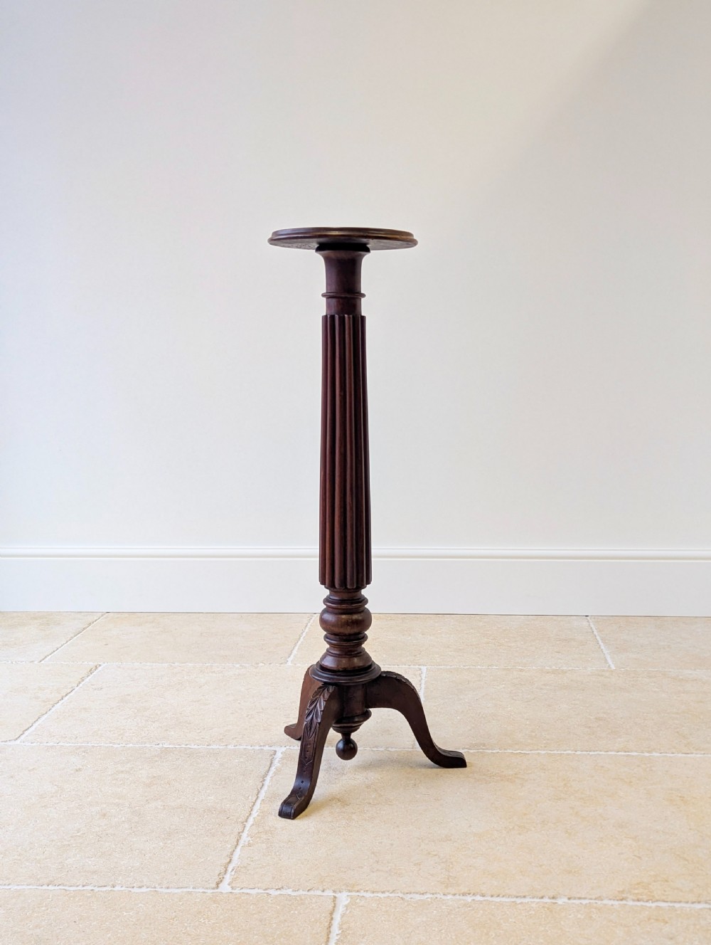 A dark mahogany William IV torchere stand featuring a fluted column shaft resting on a turned tripod base. View XII