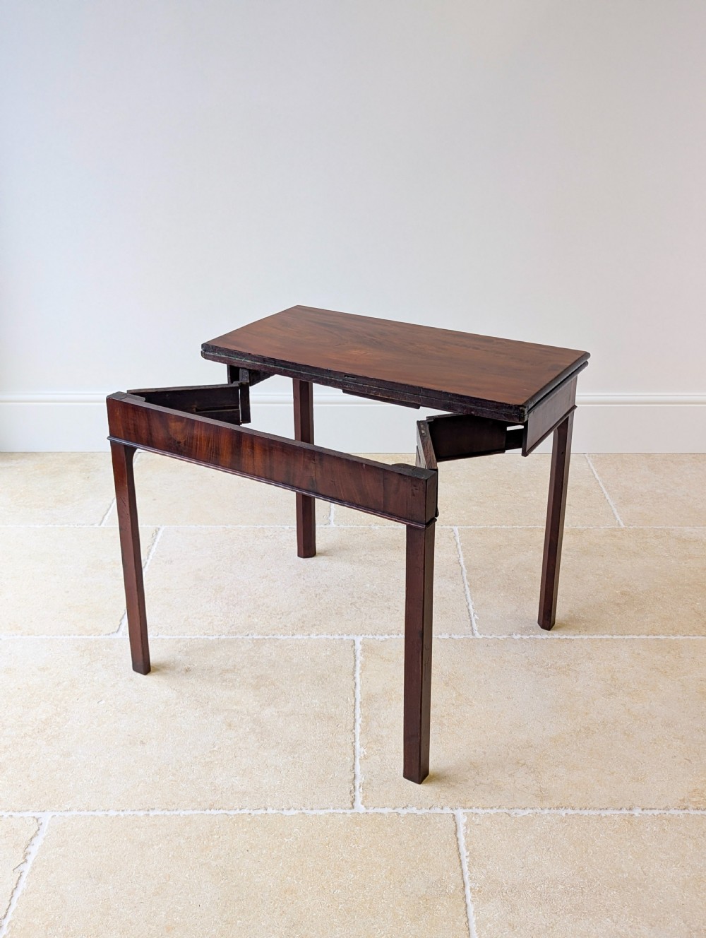 A Regency mahogany flip-top card table with square legs and a flame mahogany frieze. View III