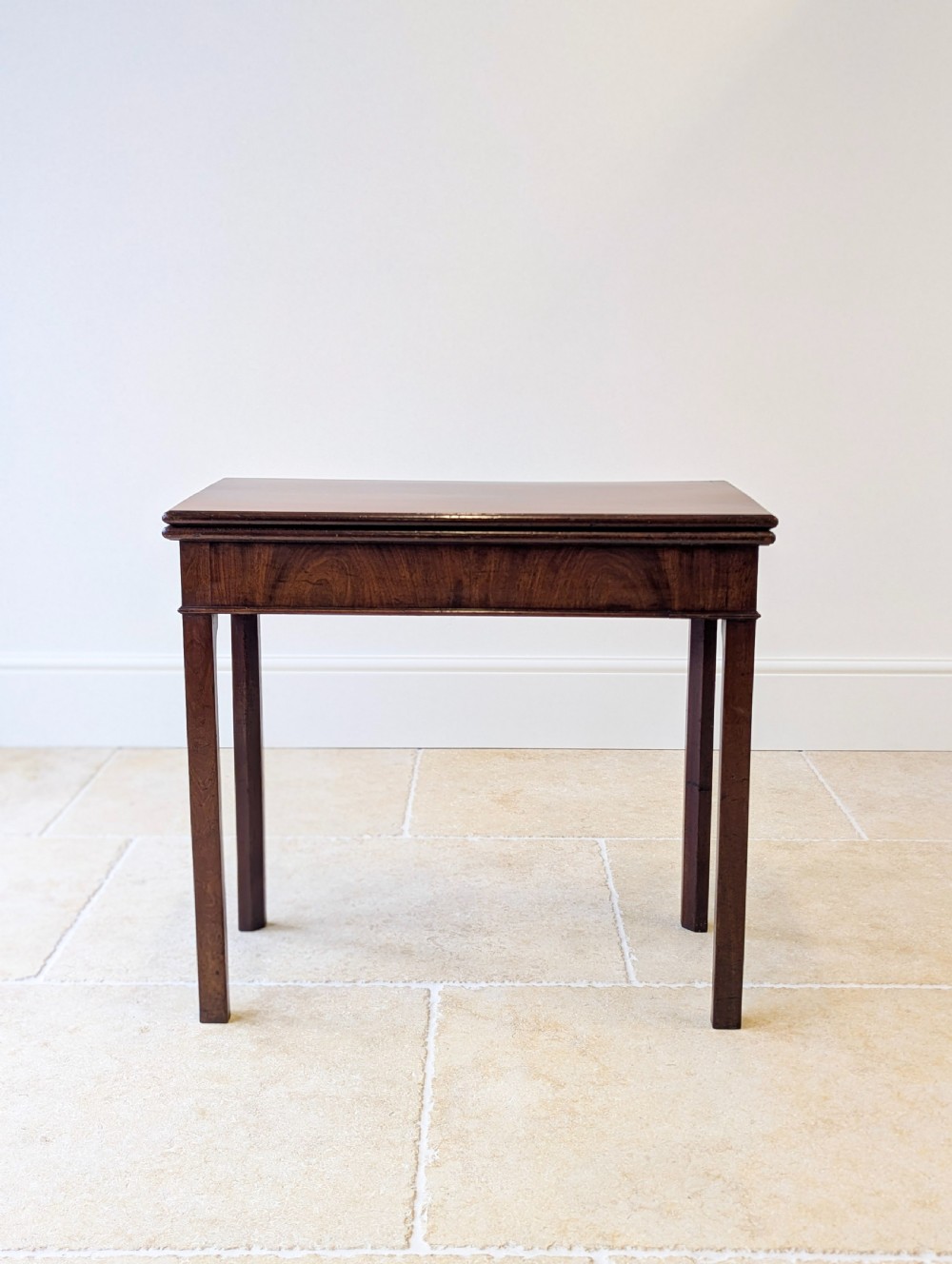 A Regency mahogany flip-top card table with square legs and a flame mahogany frieze. View IV