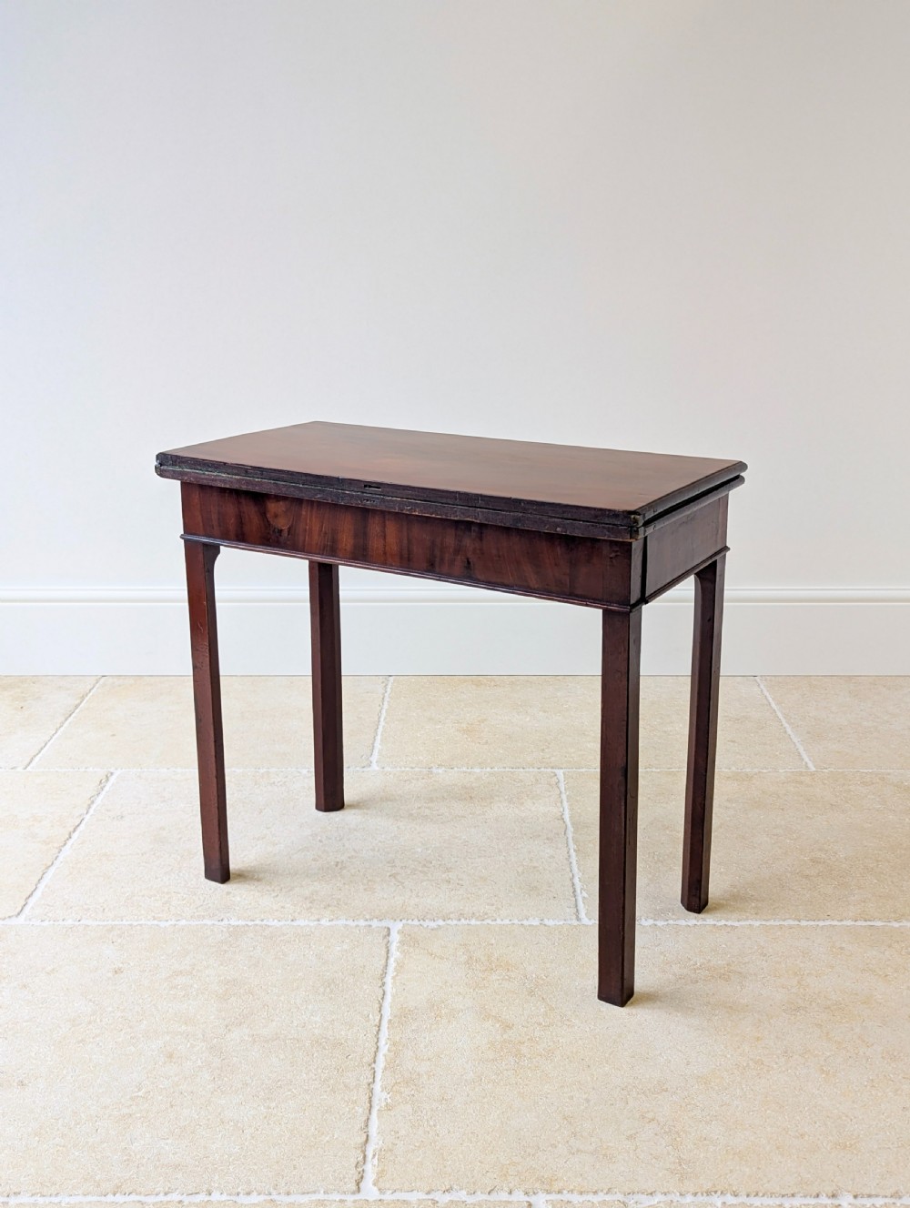 A Regency mahogany flip-top card table with square legs and a flame mahogany frieze. View IX