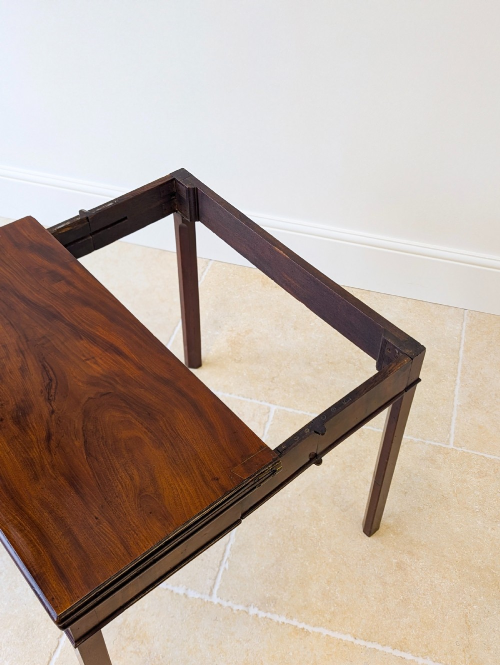 A Regency mahogany flip-top card table with square legs and a flame mahogany frieze. View XIV