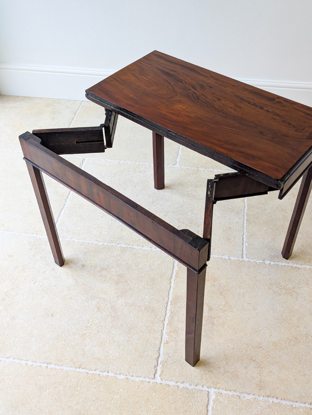 A Regency mahogany flip-top card table with square legs and a flame mahogany frieze. View XVIII