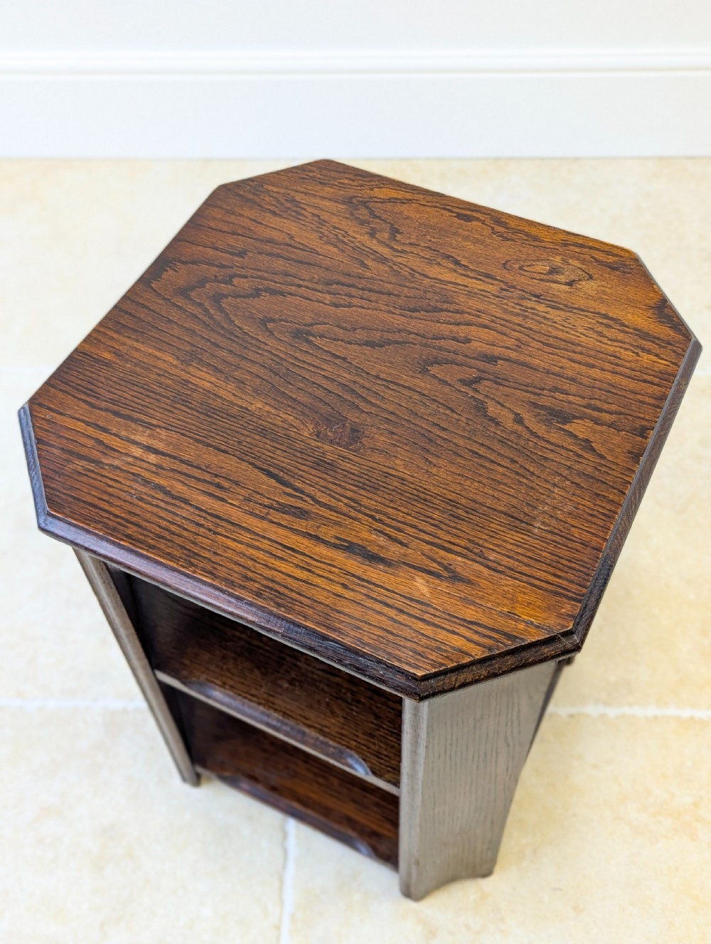 A dark brown oak book table with clipped corners on top and two open lower shelves supported by straight side legs. View IV