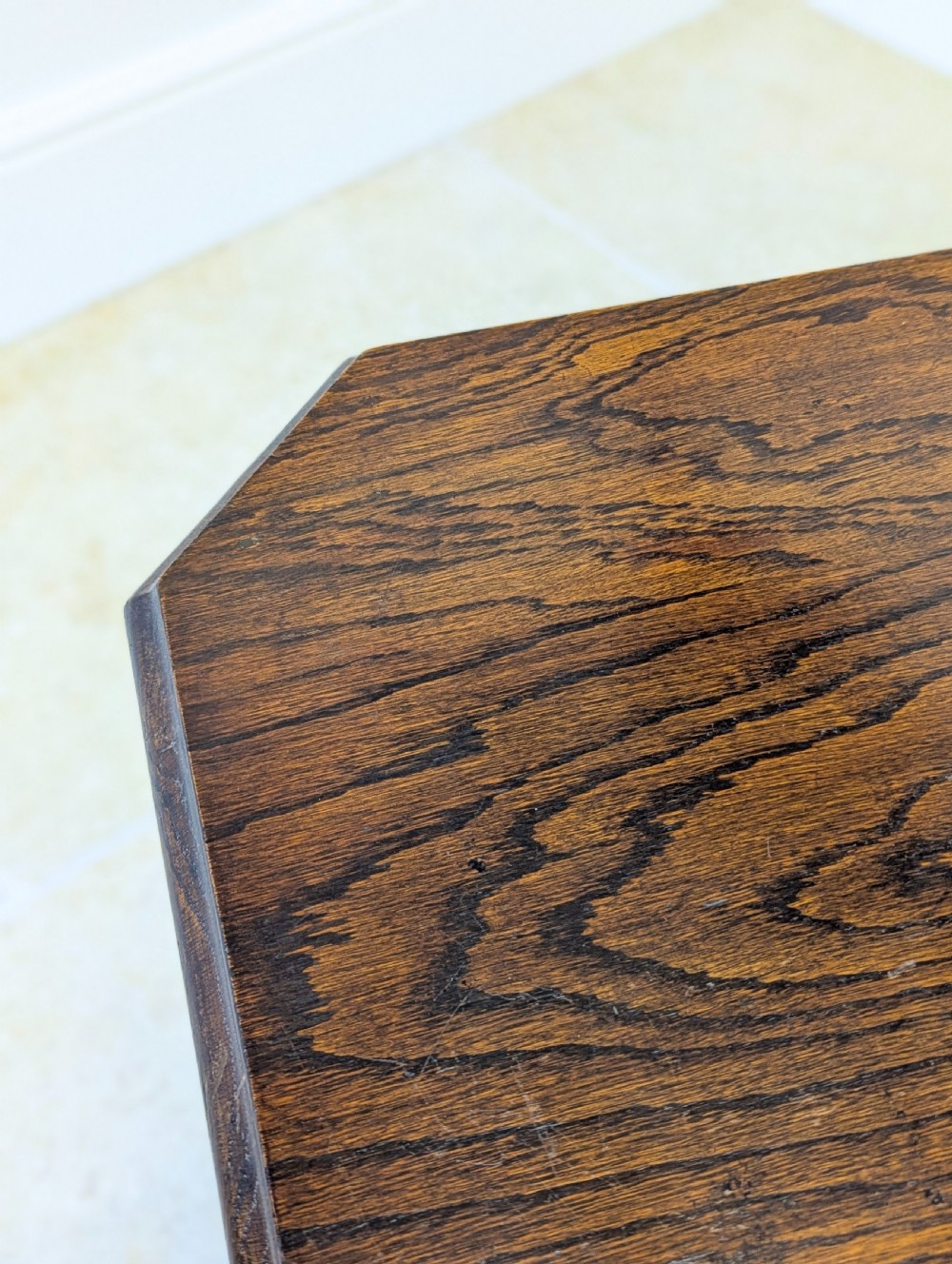 A dark brown oak book table with clipped corners on top and two open lower shelves supported by straight side legs. View XI