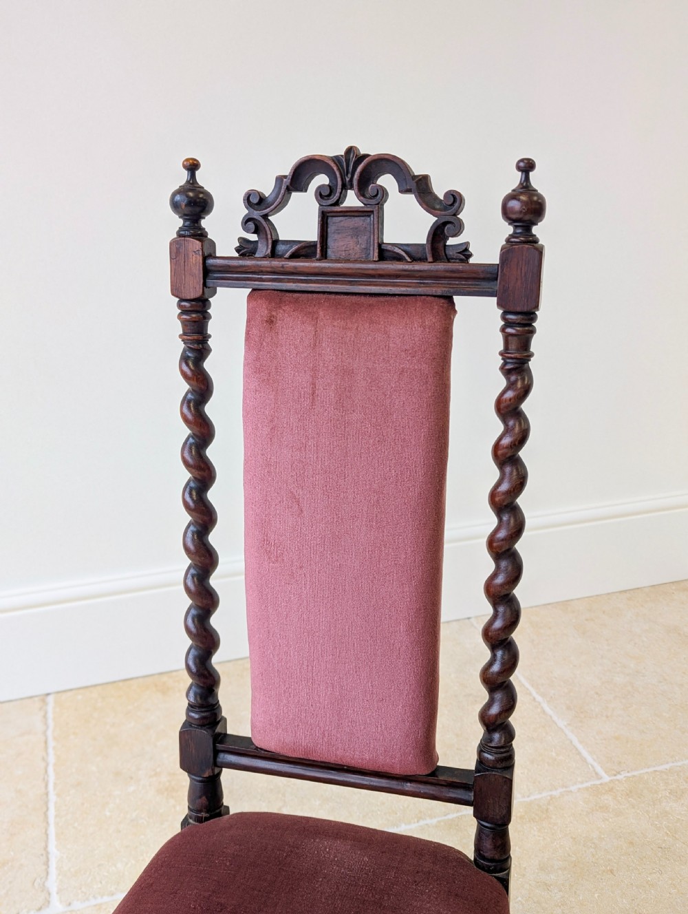A Victorian rosewood side chair featuring barley twist legs and uprights, a carved cresting rail, dusty pink velvet upholstery, and brass castors. View IV