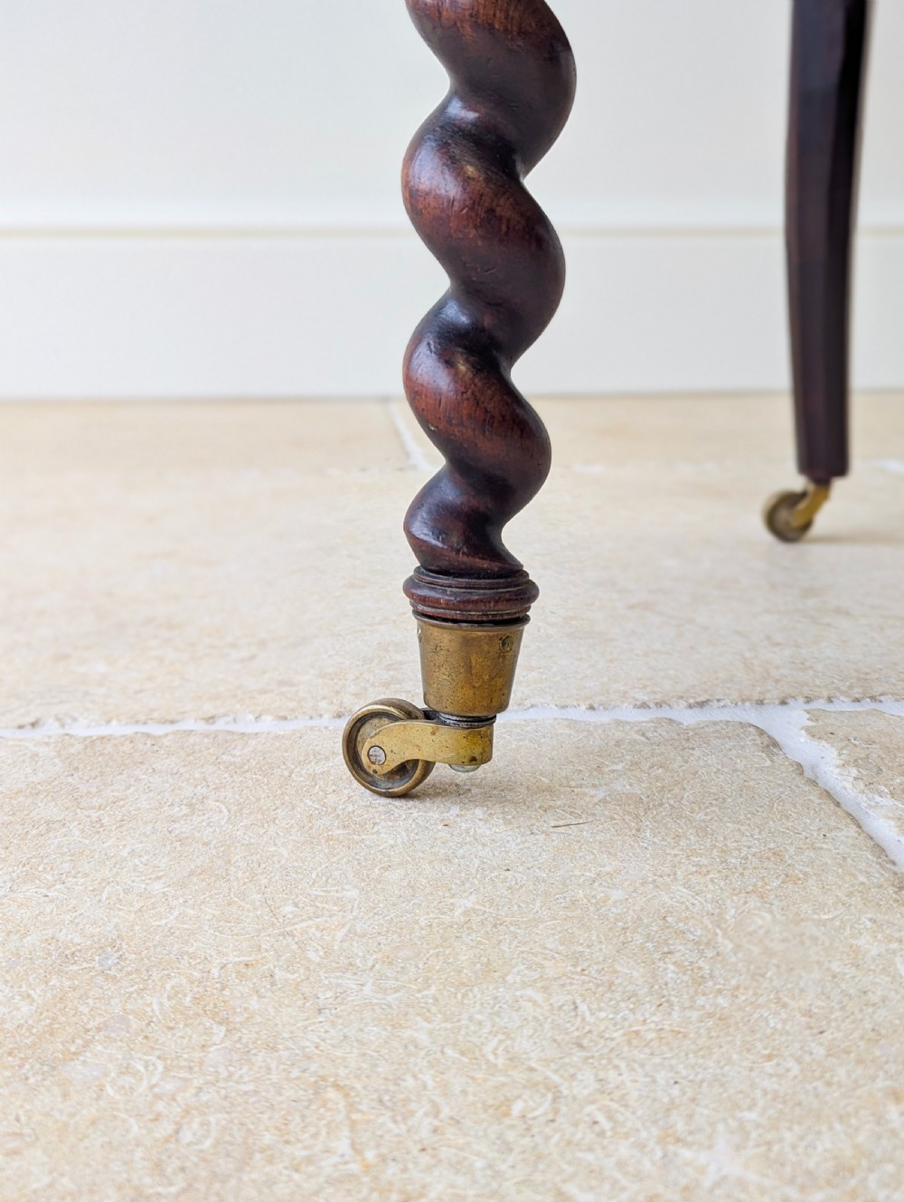 A Victorian rosewood side chair featuring barley twist legs and uprights, a carved cresting rail, dusty pink velvet upholstery, and brass castors. View X