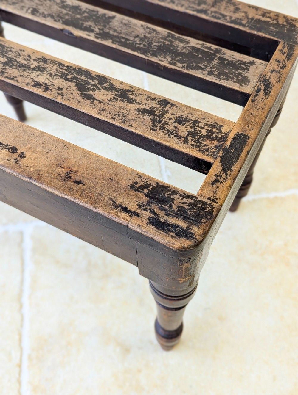 An antique Victorian dark stained beech luggage stand featuring a slatted top and four turned legs. View XI