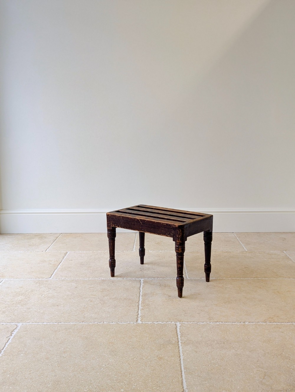 An antique Victorian dark stained beech luggage stand featuring a slatted top and four turned legs. View XIV