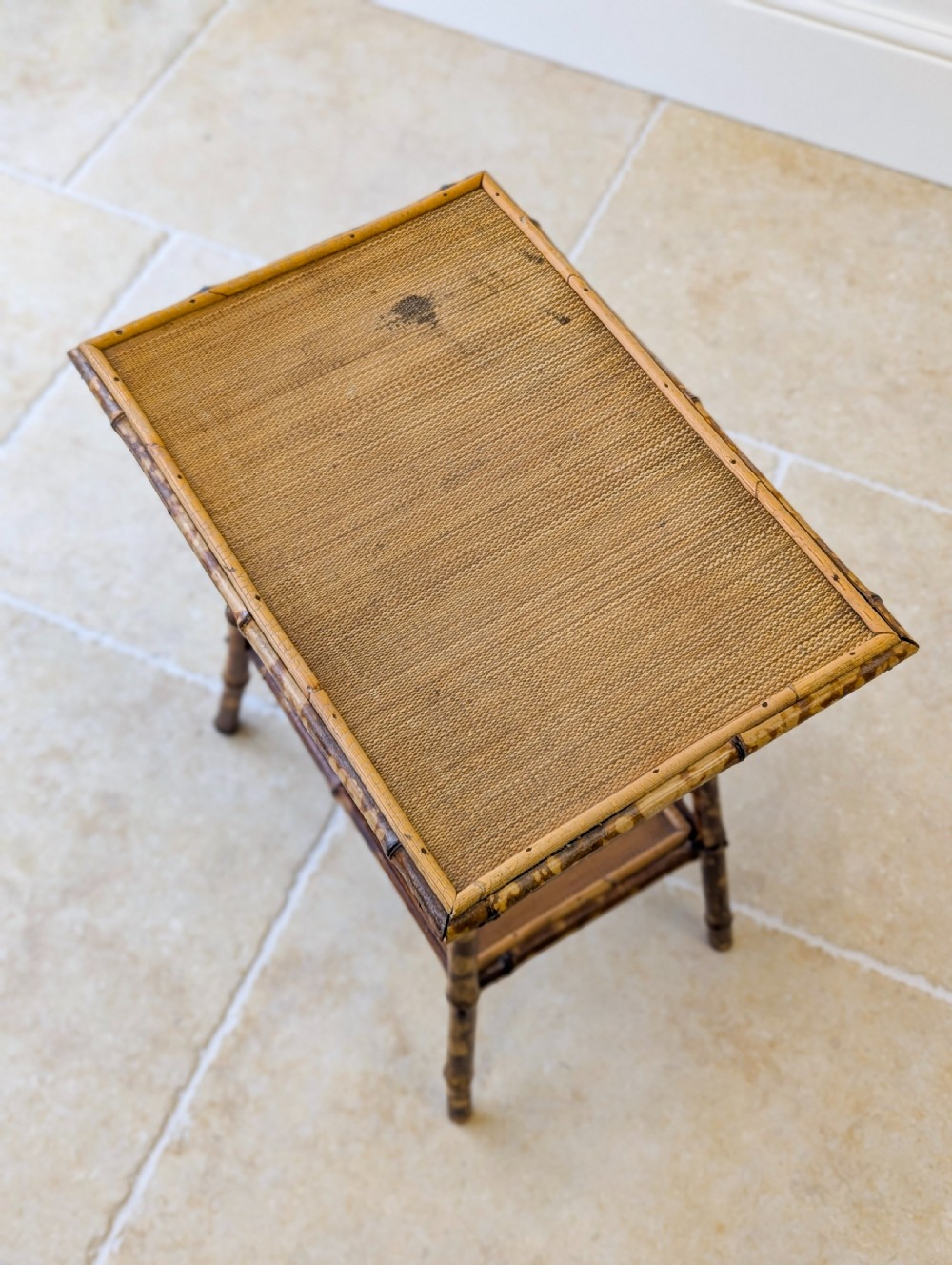 A late Victorian bamboo occasional table featuring a woven cane top surface, lower cane shelf, and splayed mottled bamboo legs. View III