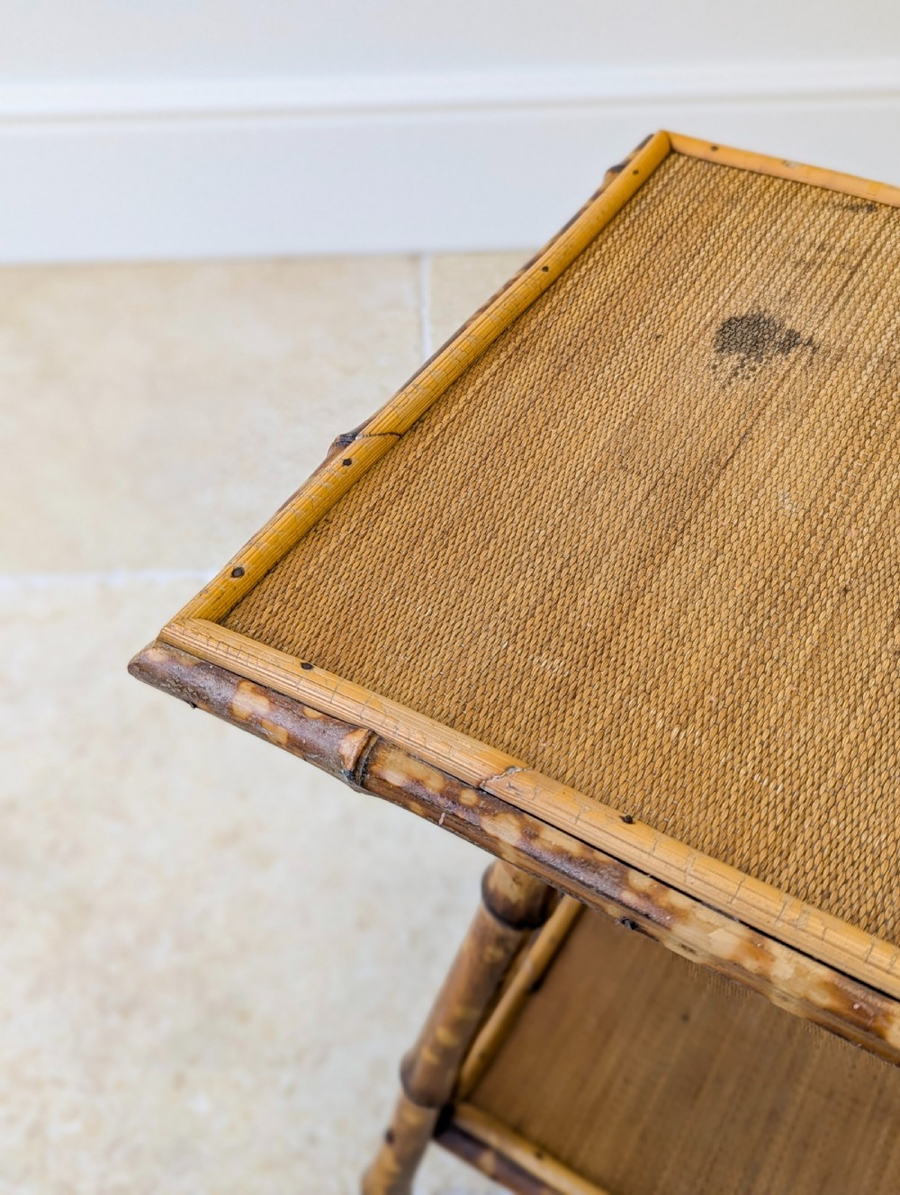 A late Victorian bamboo occasional table featuring a woven cane top surface, lower cane shelf, and splayed mottled bamboo legs. View VII