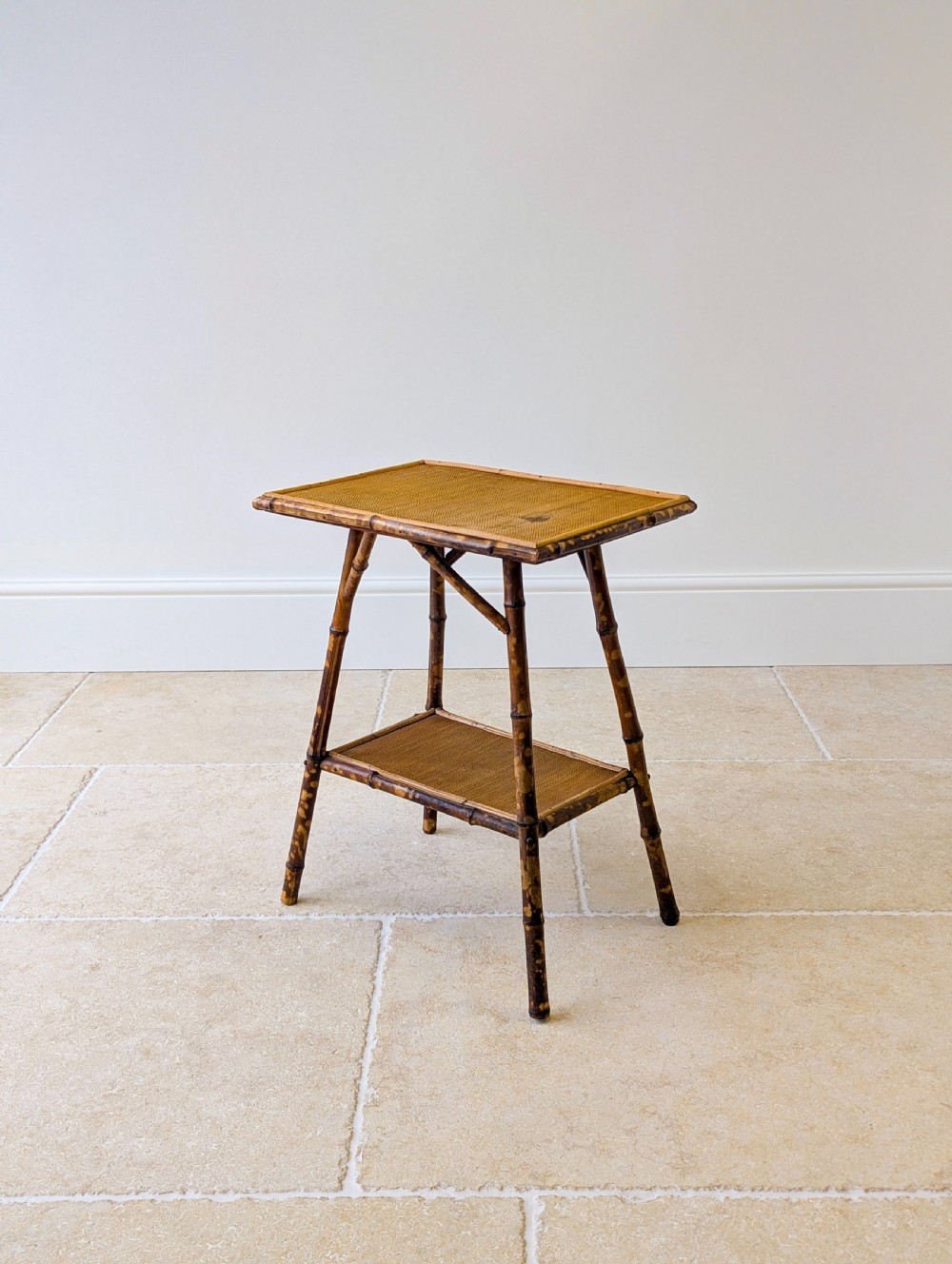 A late Victorian bamboo occasional table featuring a woven cane top surface, lower cane shelf, and splayed mottled bamboo legs. View XIII
