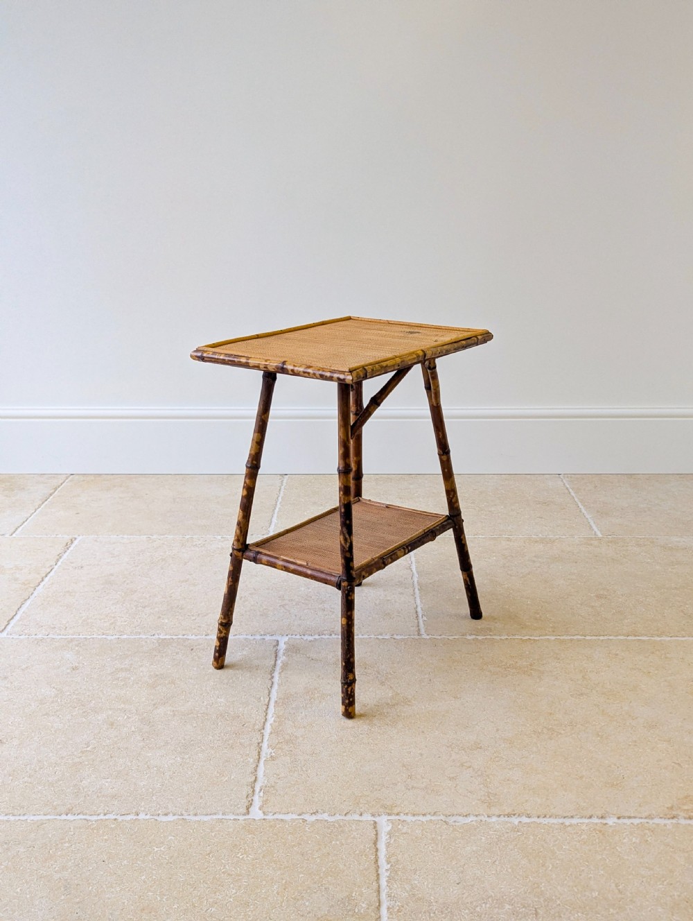 A late Victorian bamboo occasional table featuring a woven cane top surface, lower cane shelf, and splayed mottled bamboo legs. View XIV
