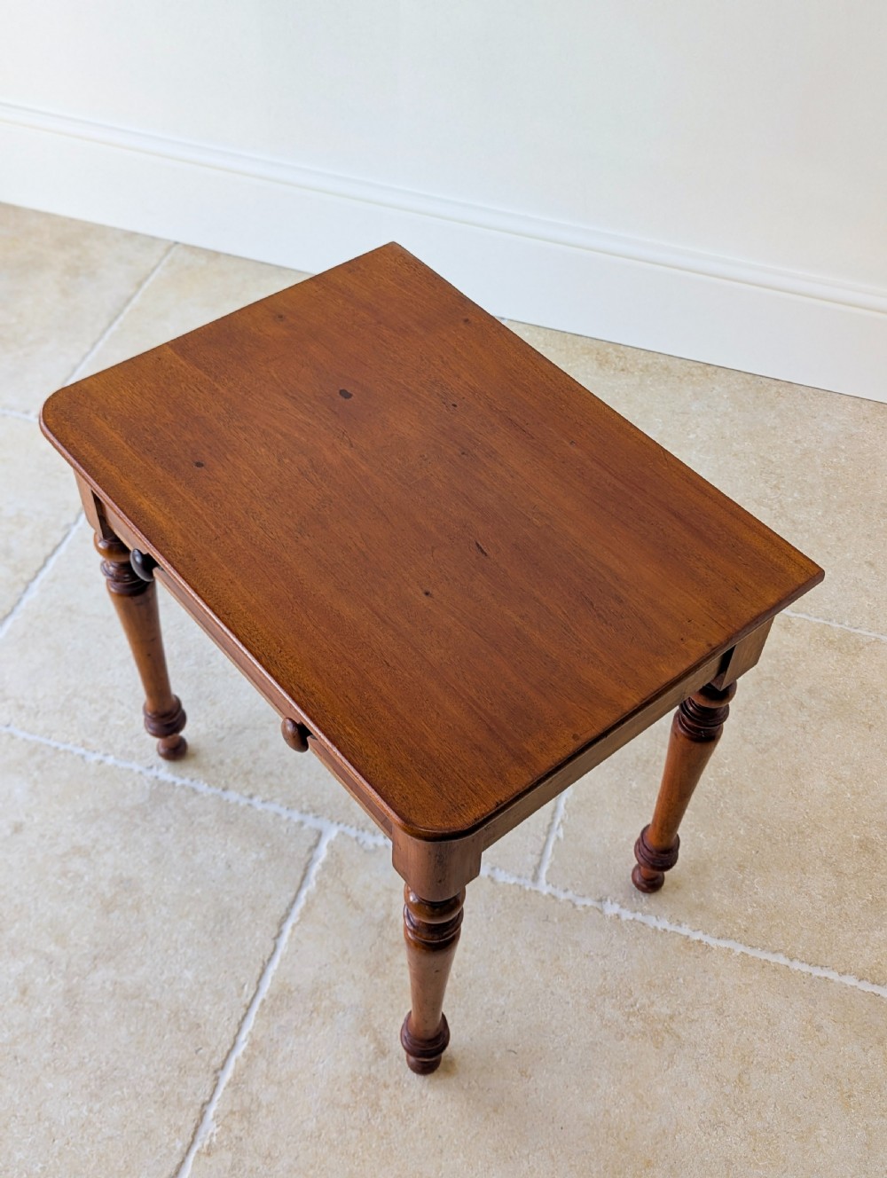 A late Victorian mahogany side table featuring a rectangular top, single drawer with two turned wooden knobs, and four turned legs. View II