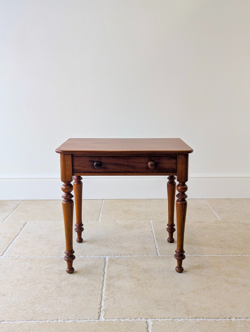 A late Victorian mahogany side table featuring a rectangular top, single drawer with two turned wooden knobs, and four turned legs. View III