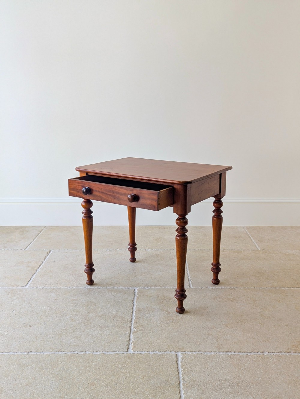 A late Victorian mahogany side table featuring a rectangular top, single drawer with two turned wooden knobs, and four turned legs. View IV
