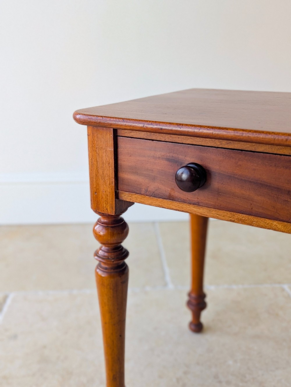 A late Victorian mahogany side table featuring a rectangular top, single drawer with two turned wooden knobs, and four turned legs. View VI