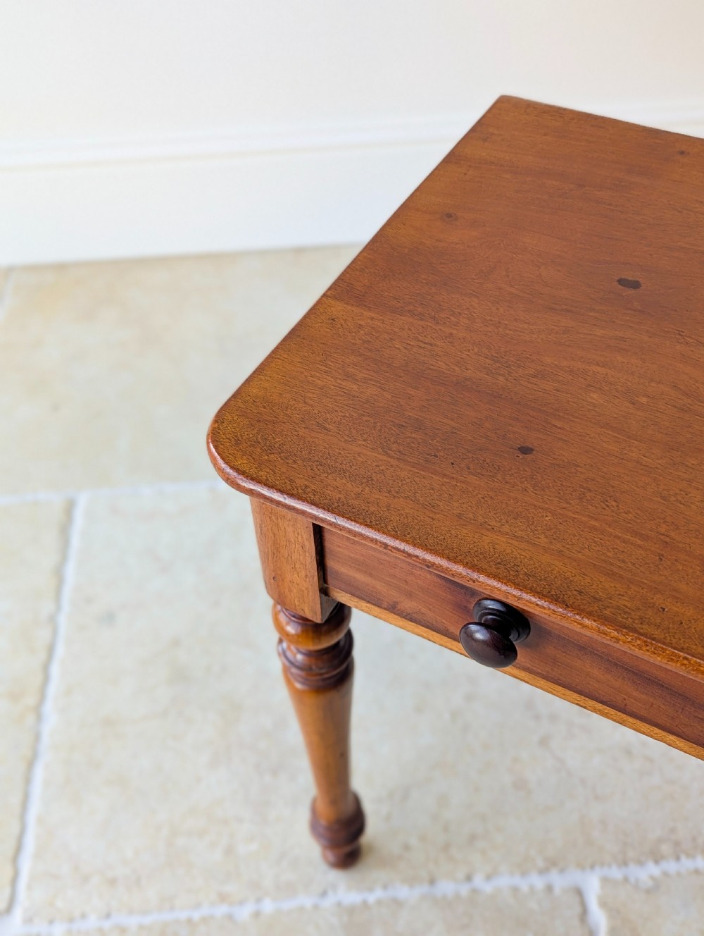 A late Victorian mahogany side table featuring a rectangular top, single drawer with two turned wooden knobs, and four turned legs. View X