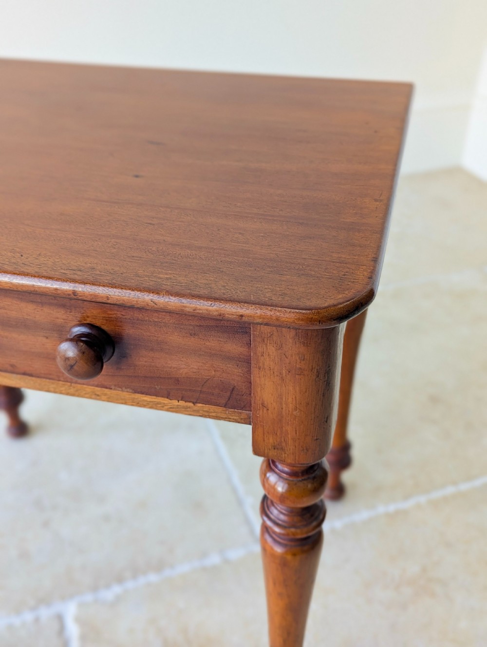 A late Victorian mahogany side table featuring a rectangular top, single drawer with two turned wooden knobs, and four turned legs. View XI