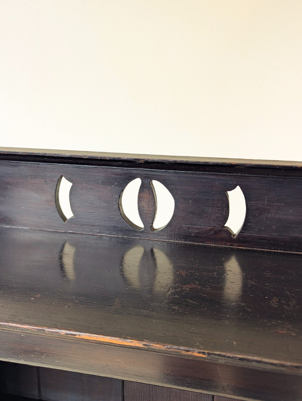 A tall, narrow late Victorian dark stained pine bookcase featuring four open shelves, a planked backboard, and a gallery top with pierced cutouts. View VIII