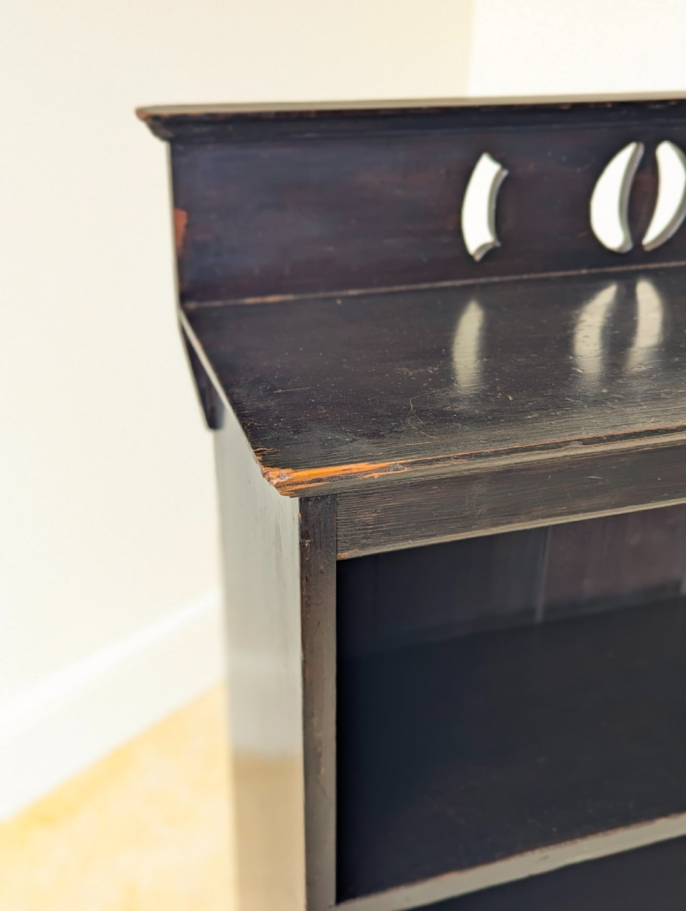 A tall, narrow late Victorian dark stained pine bookcase featuring four open shelves, a planked backboard, and a gallery top with pierced cutouts. View X