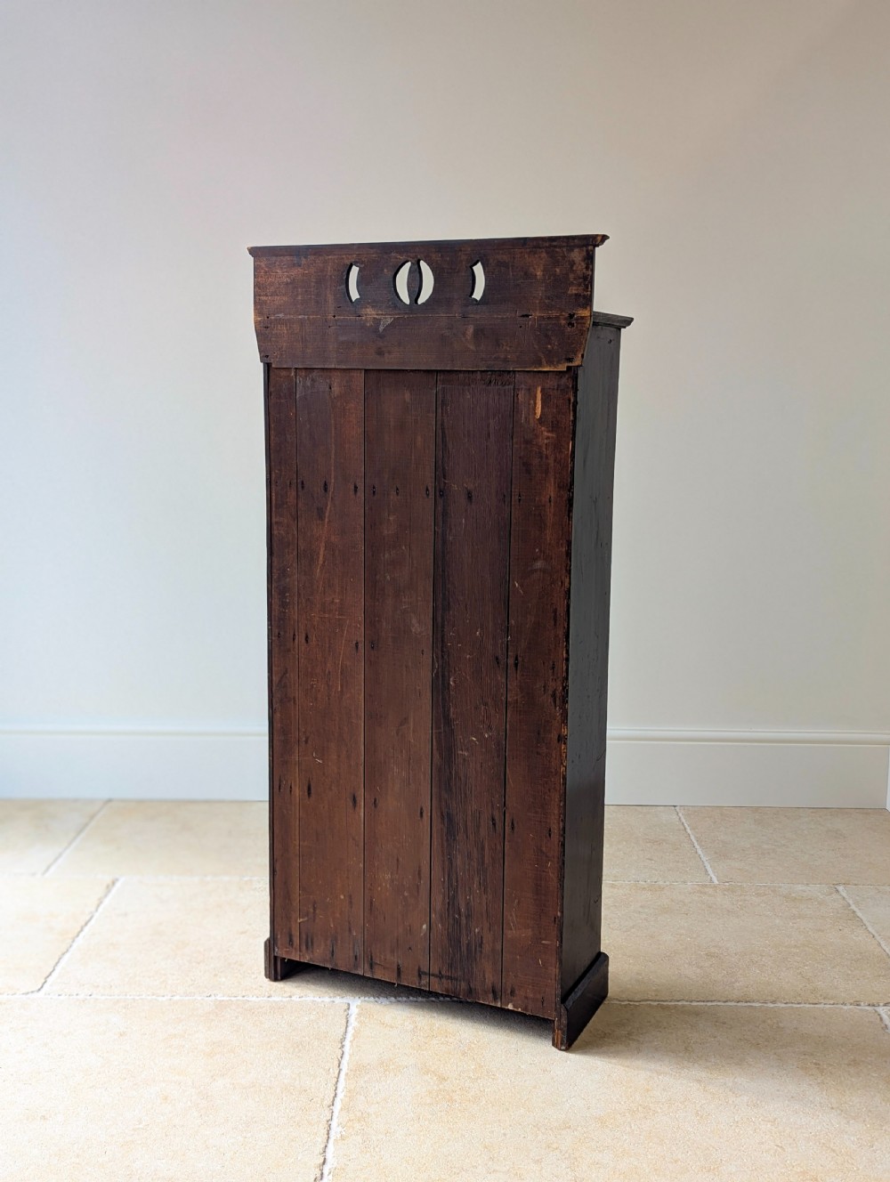 A tall, narrow late Victorian dark stained pine bookcase featuring four open shelves, a planked backboard, and a gallery top with pierced cutouts. View XIV