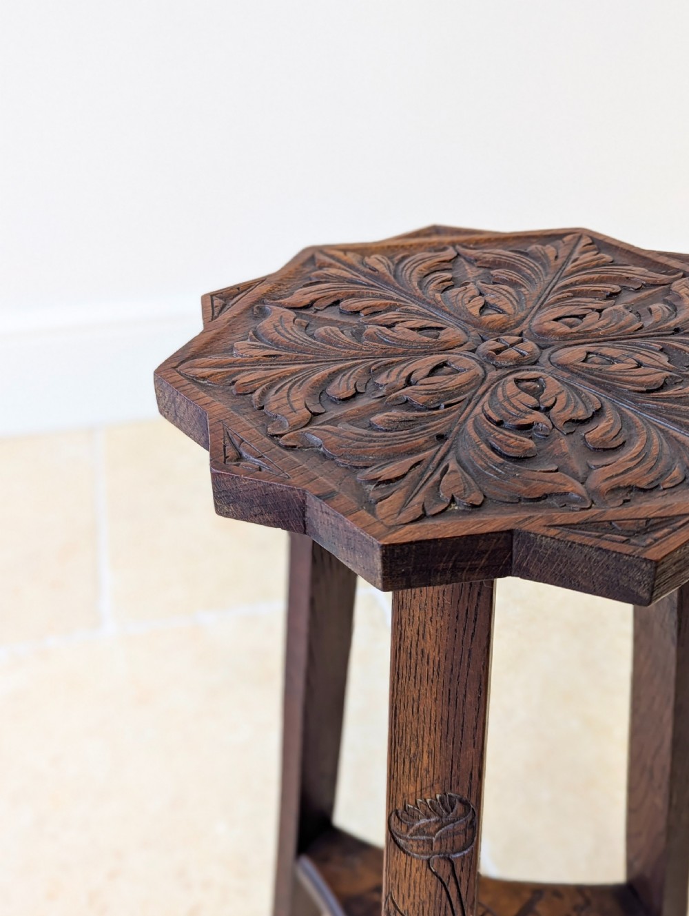 An antique dark oak three-legged occasional table featuring an octagonal carved top and triangular stretcher shelf. View VI