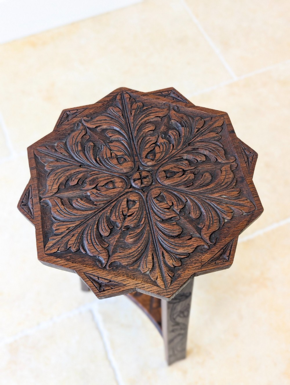 An antique dark oak three-legged occasional table featuring an octagonal carved top and triangular stretcher shelf. View XII