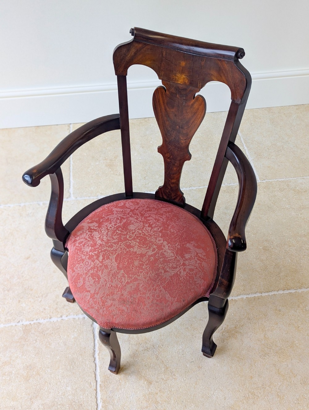 An antique mid-18th century Georgian open armchair crafted from dark mahogany wood featuring a shaped back splat, curved armrests, cabriole front legs, and a red patterned fabric seat. View III