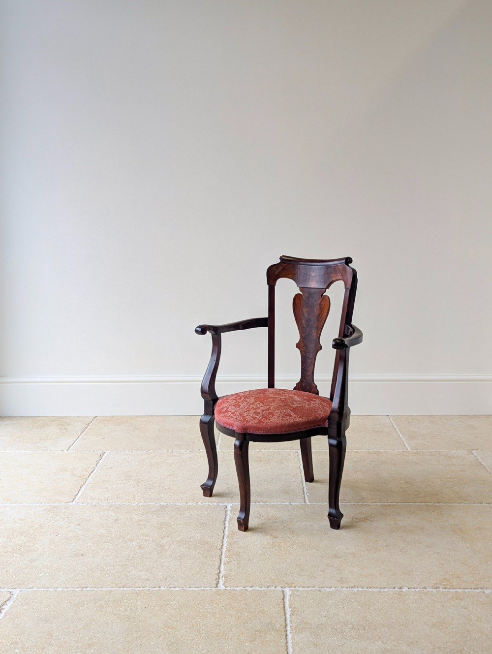 An antique mid-18th century Georgian open armchair crafted from dark mahogany wood featuring a shaped back splat, curved armrests, cabriole front legs, and a red patterned fabric seat. View V