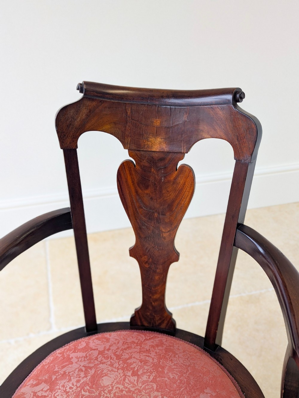 An antique mid-18th century Georgian open armchair crafted from dark mahogany wood featuring a shaped back splat, curved armrests, cabriole front legs, and a red patterned fabric seat. View VI